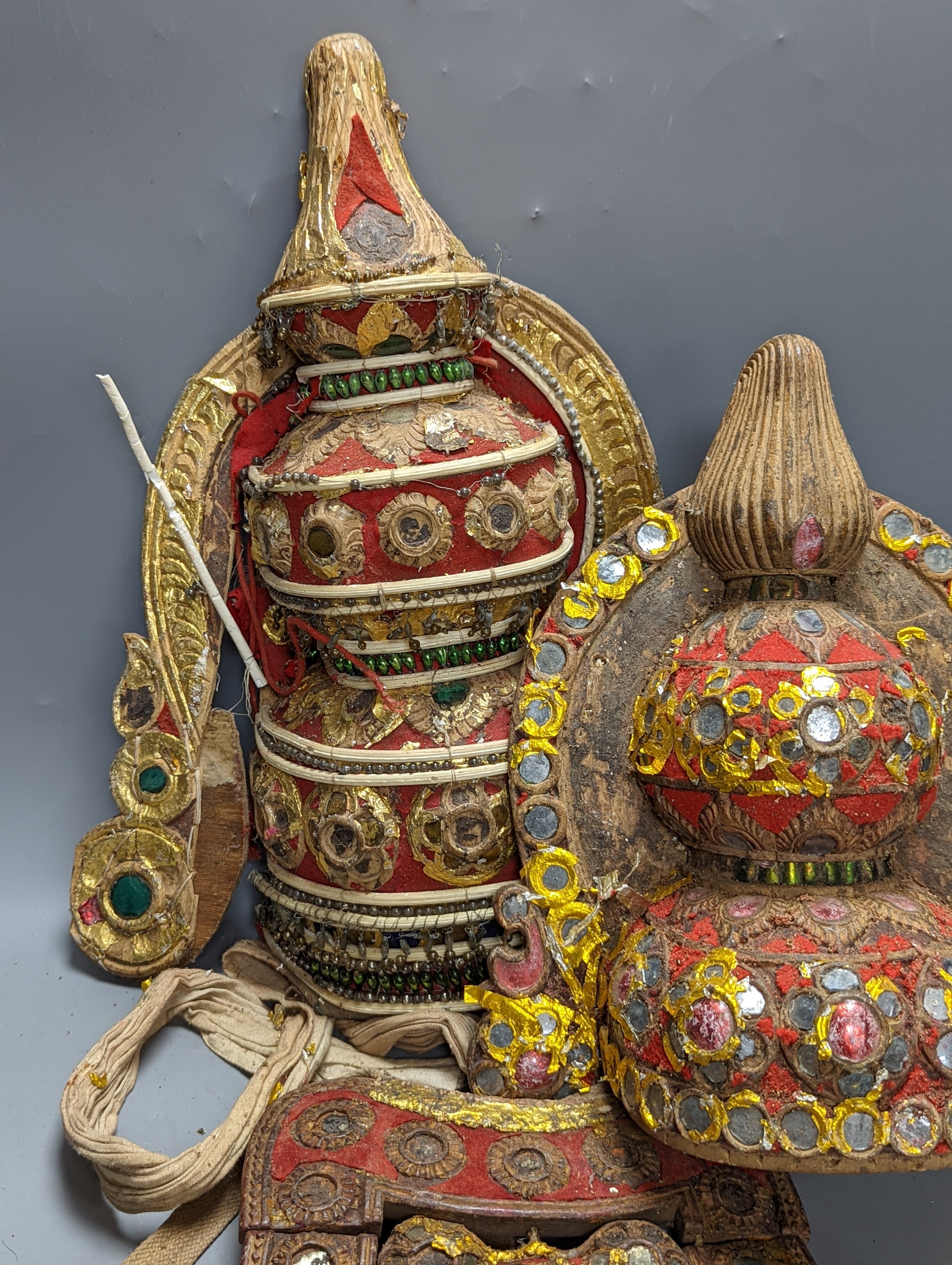 A group of Indian ornate wooden headdresses, masks etc